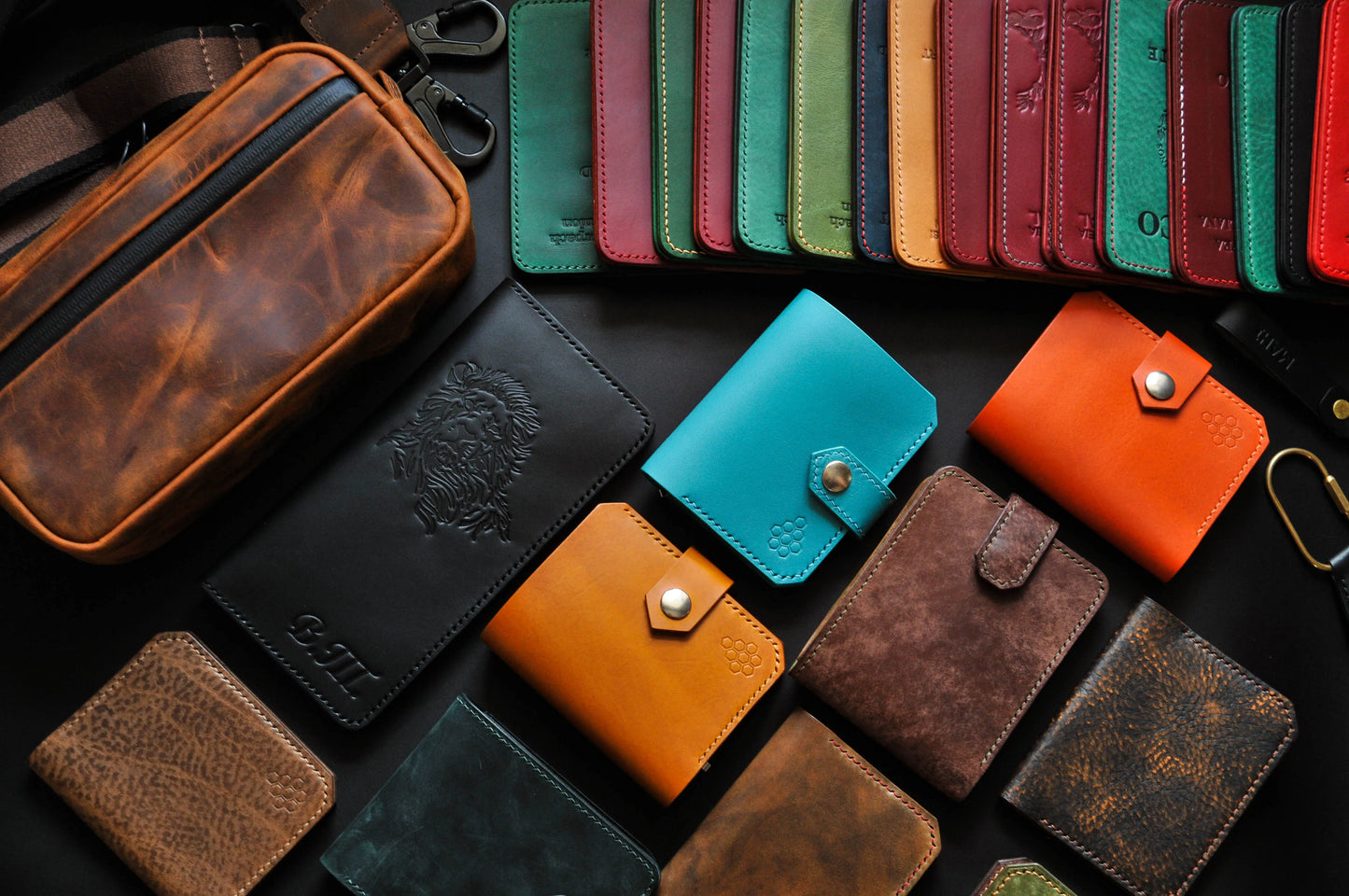 Collection of various leather wallets in different colors on a dark surface